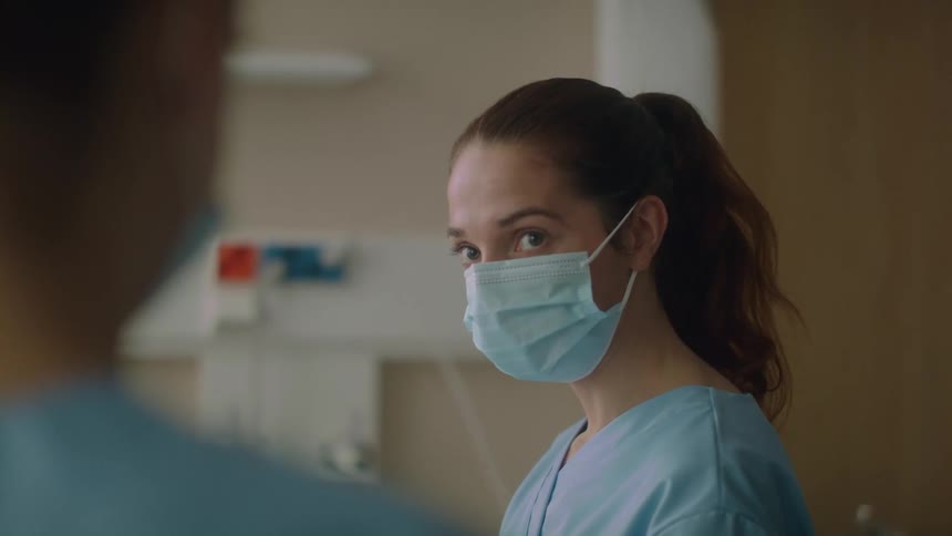 A woman talking to people in a hospital