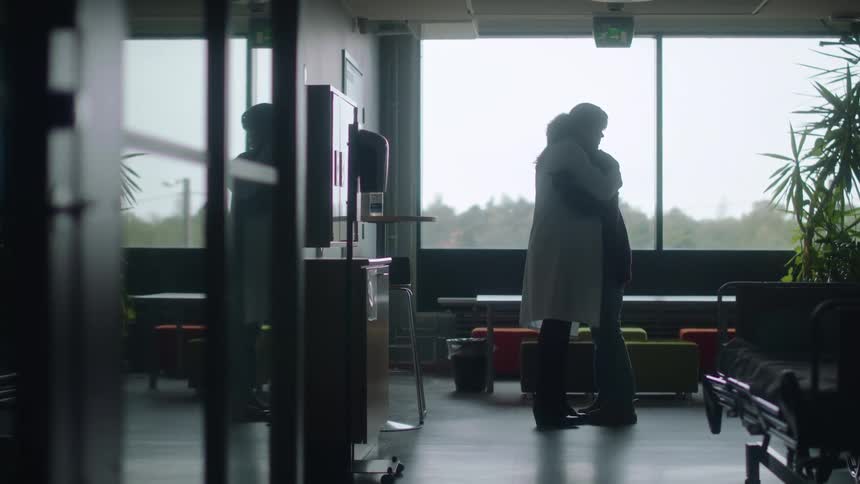 A female doctor informs a woman of a loved ones death and comforts her with hugging in the daytime