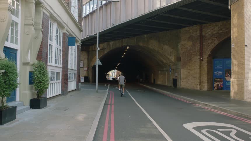 Man rides a bicycle inside a tunnel in the city