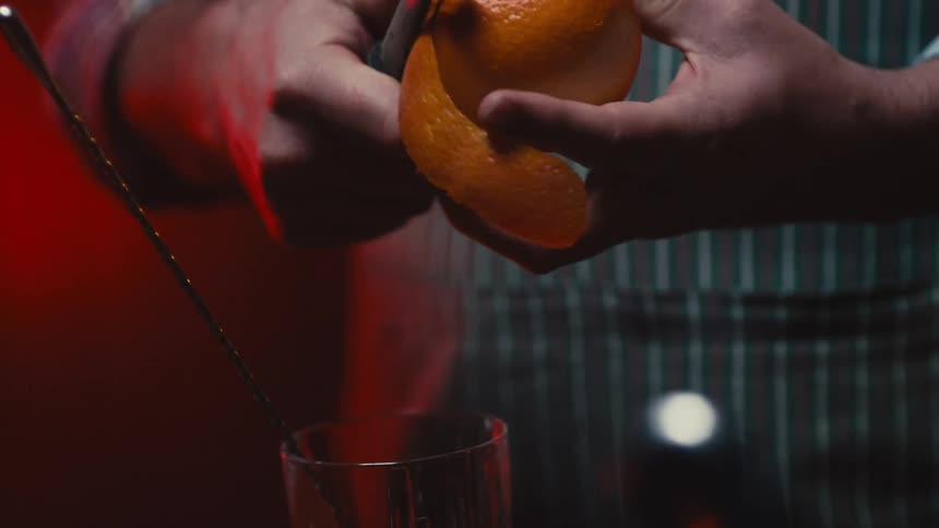 Person peeling an orange