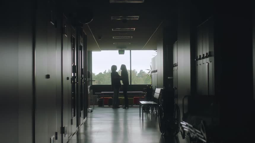 A man enters the door in the hallway