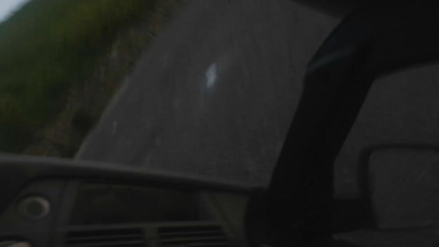 Point of view footage of a car rolling down a hill crashing on a road at sunset
