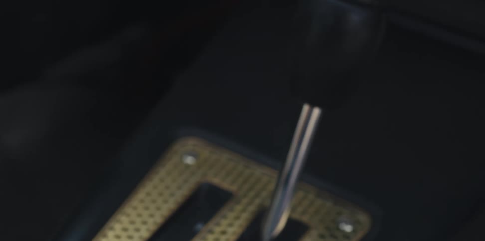 Hand of a man shifting gears on a car up and down