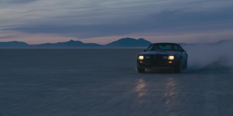 A car is driving in the desert