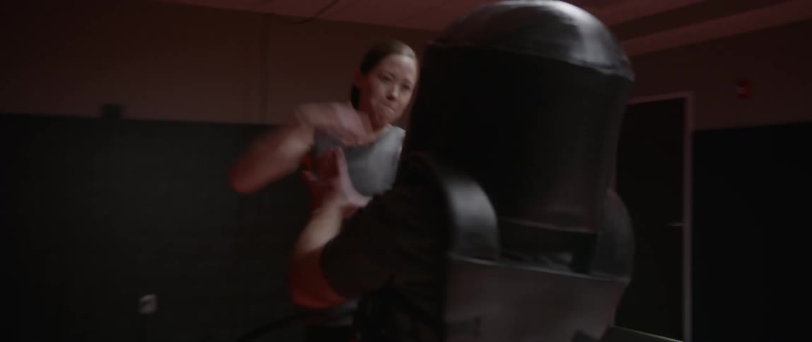 A woman slaps and attacks a man in a foam helmet