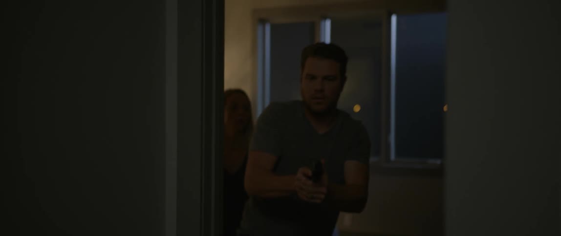 A man jumps up out of bed with a gun and leaves their room