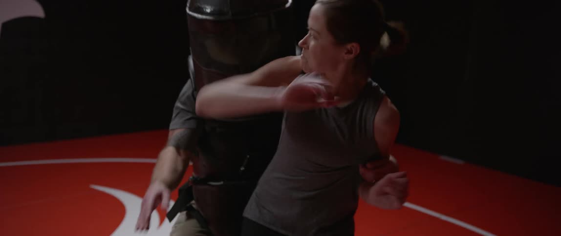 A woman reacts to an attacker in a self-defense class