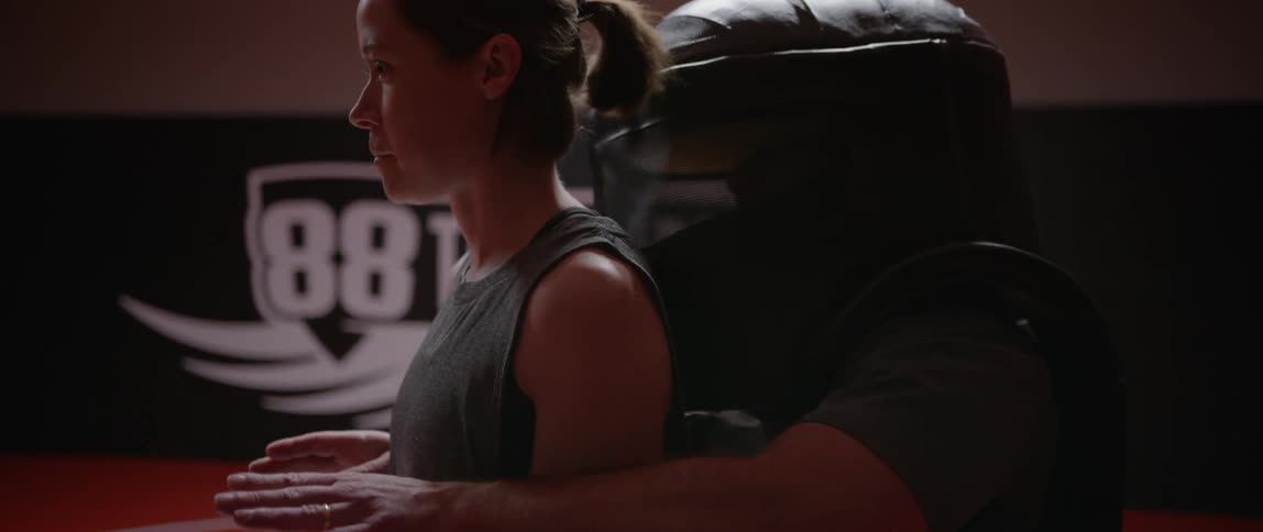 A woman demonstrates a defensive move