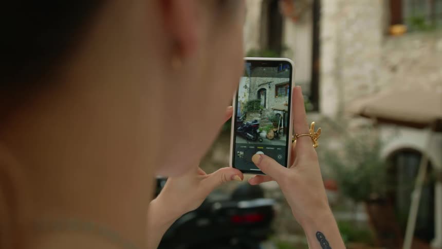 A woman using a smartphone to take a photo