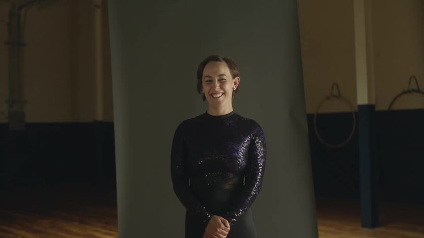 Portrait of a dancer in a dance studio at night smiling and laughing toward the camera