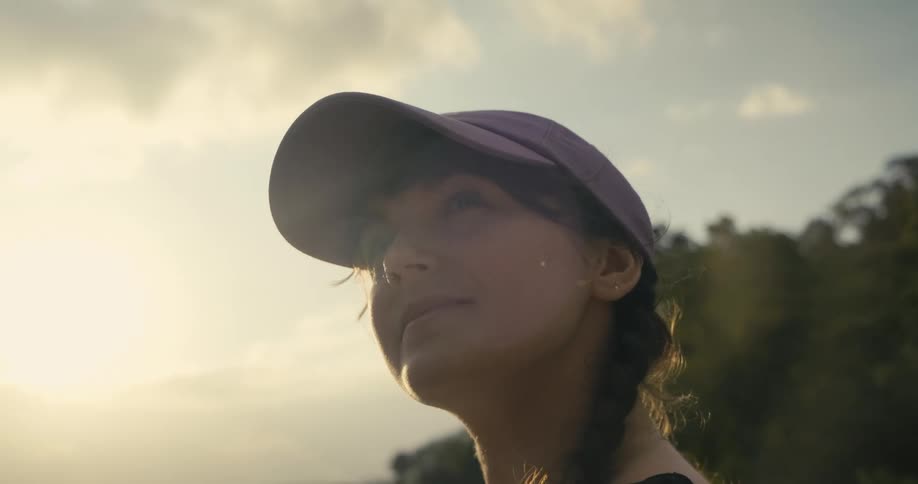 A woman standing outside looks around