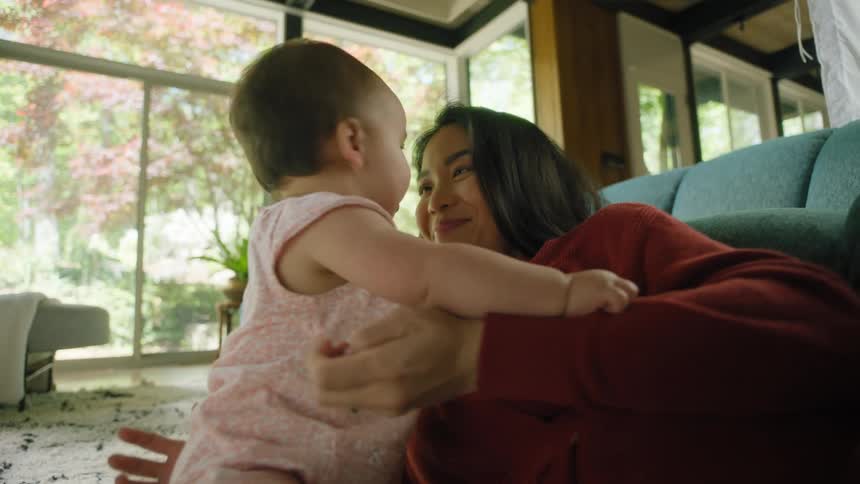 A mother and her daughter playing indoors