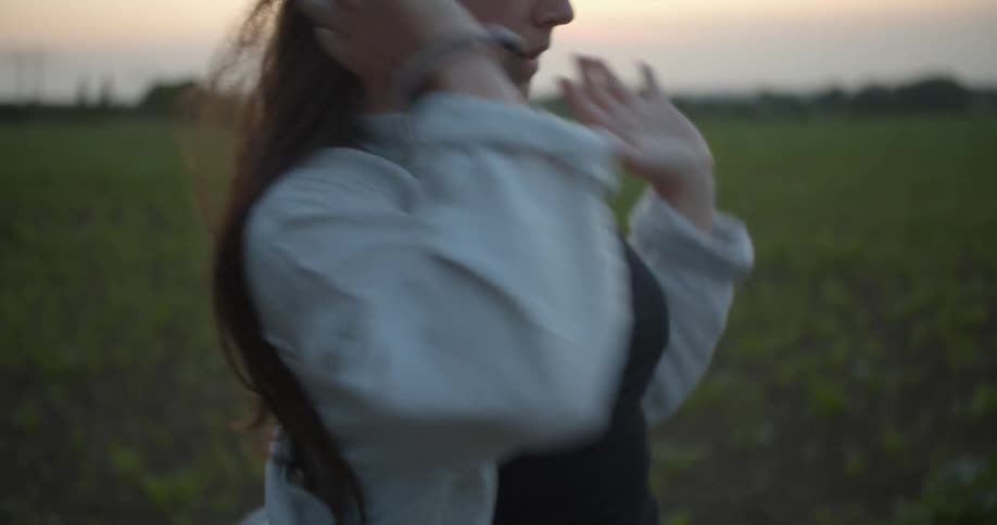 A man dances around in an open field