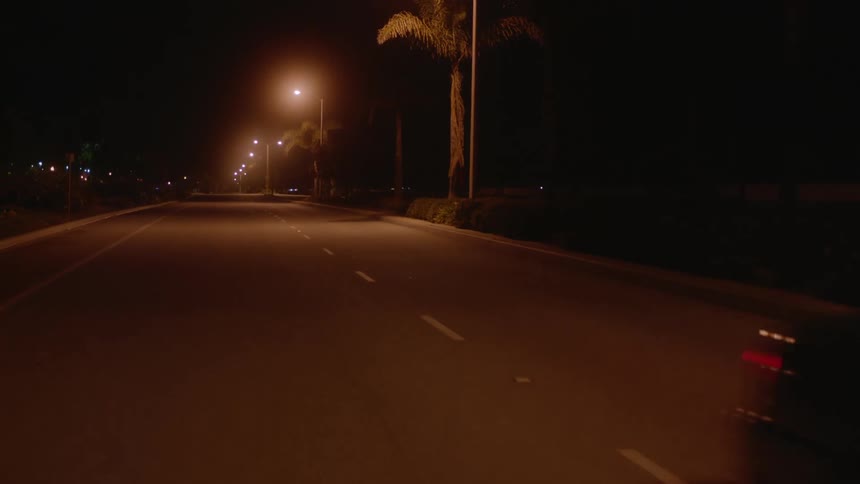 A car driving down a road at night
