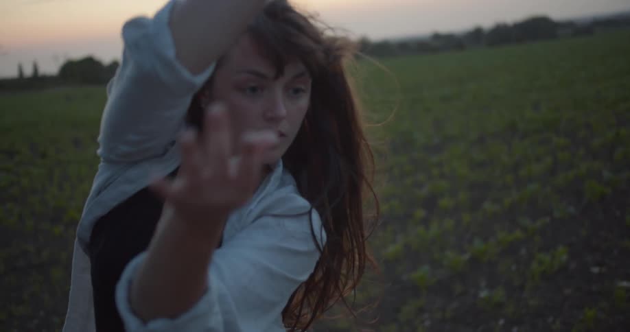 A woman dancing out in a field