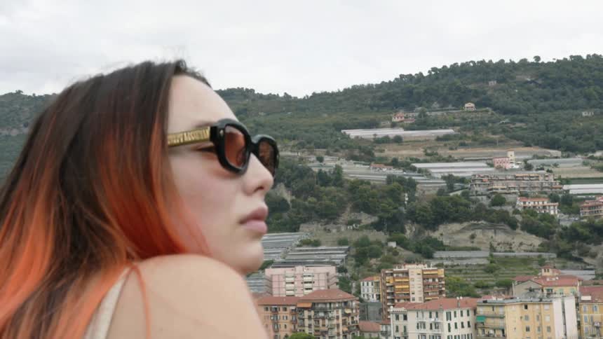 A teenage girl looks out at a city skyline
