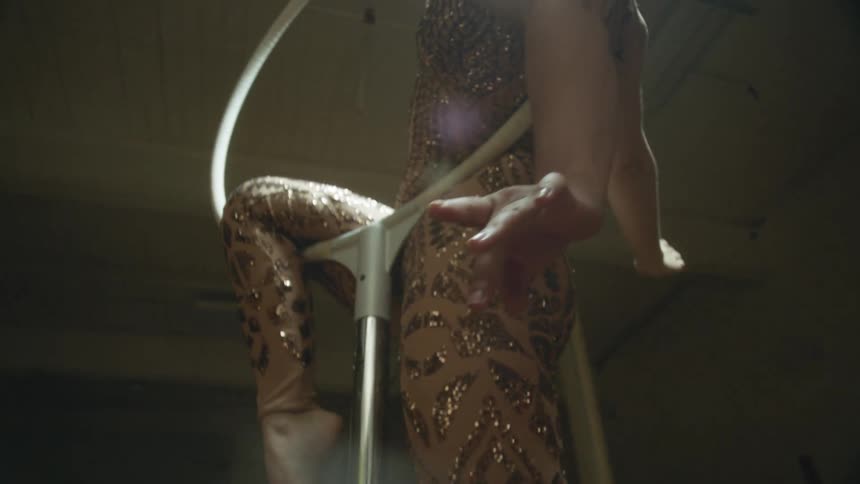 A woman in costume hangs on the ring
