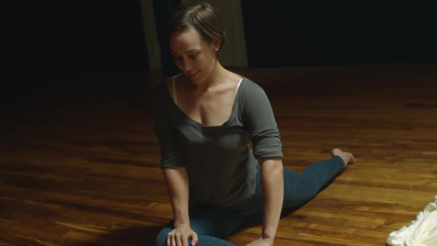 A woman stretching and doing yoga in a room