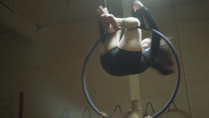 Two women doing gymnastics in a gym