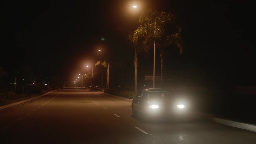 A view of a car driving down an asphalt road