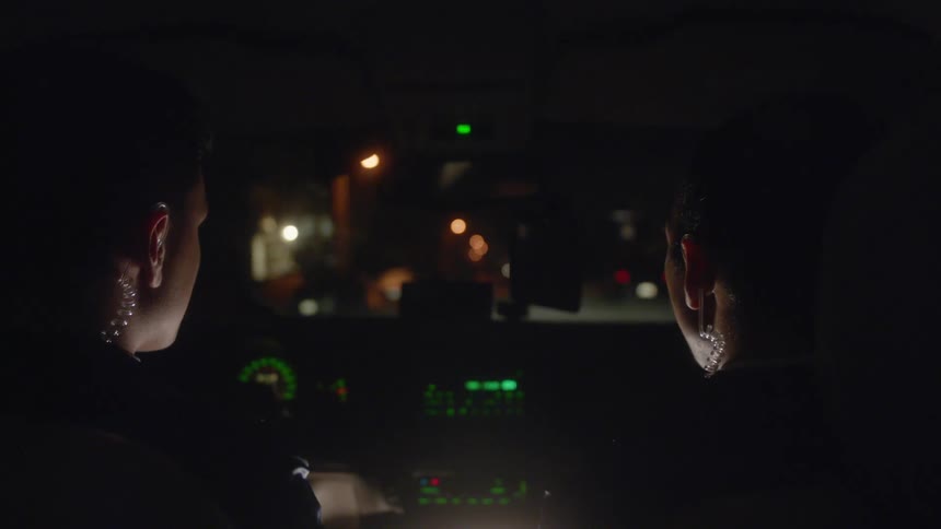 Two police are driving on the road at night