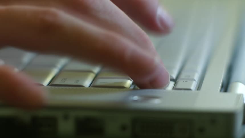 Fingers are quickly typing on a keyboard