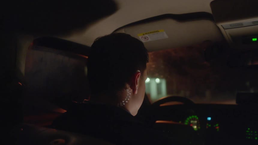 A man driving a vehicle with a steering wheel
