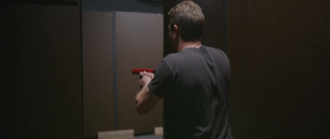 A man is training with a gun moving around a range