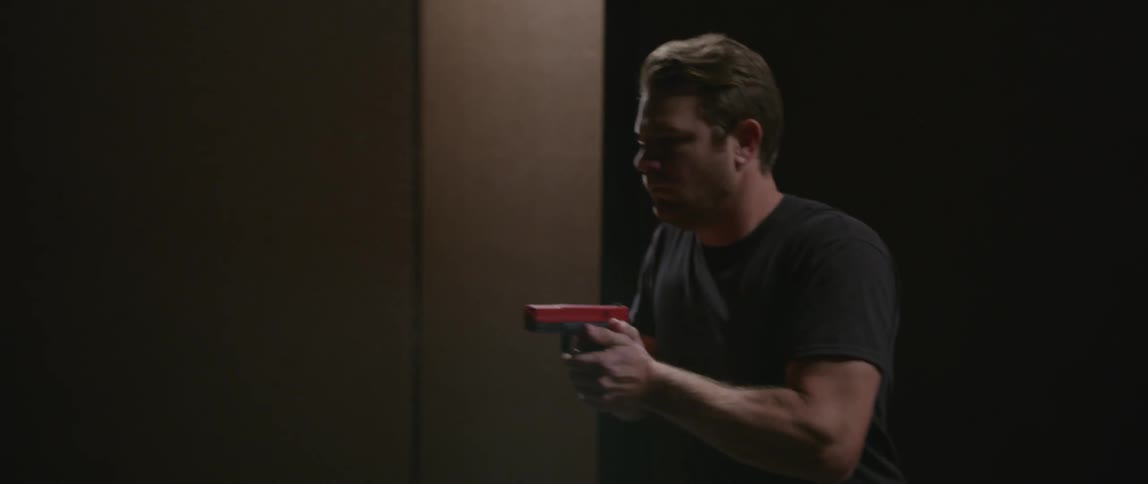 Man searching a place holding a pistol