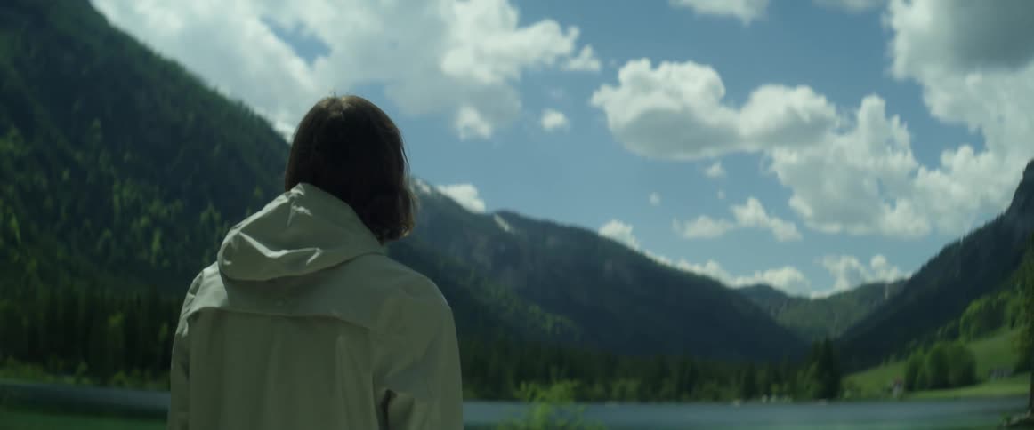 A man walks up to the lake