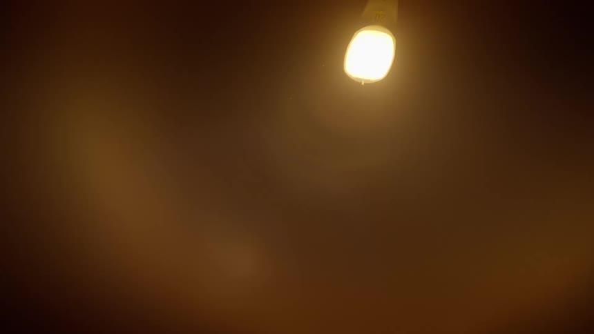 A bright light is shining through some smoke
