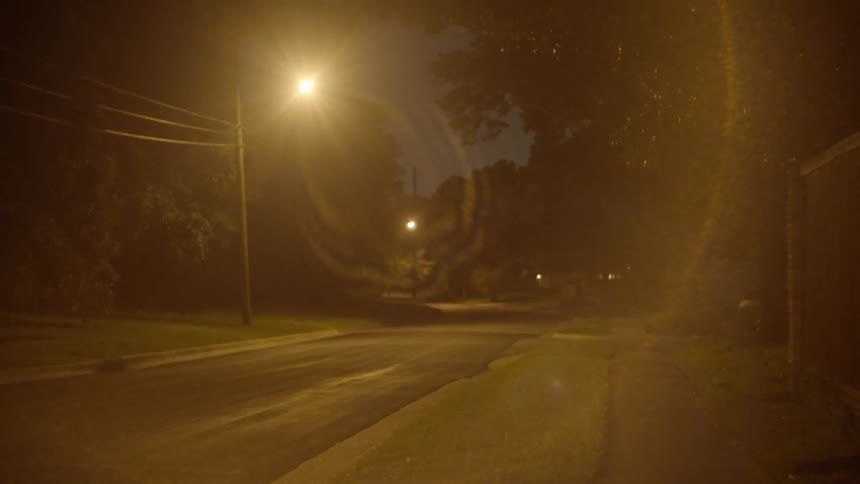 City street illuminated by street lights at night