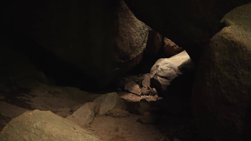 A cave with rocks and sunlight