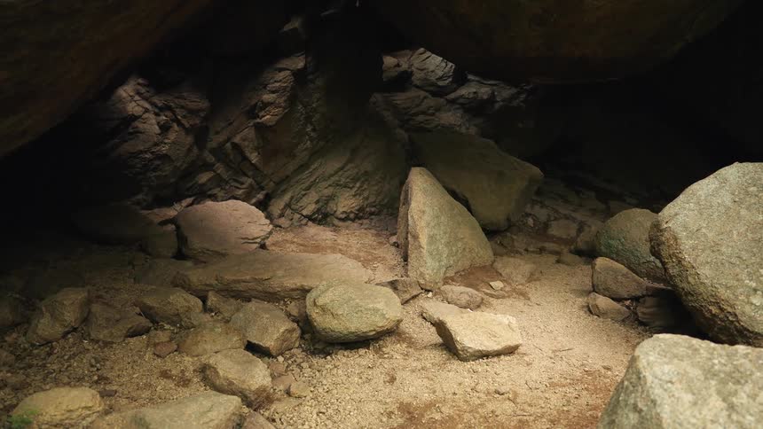 Inside a cave with rocks and debris from a previous cavein in the daytime