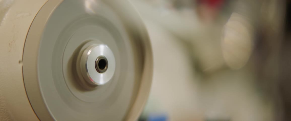 A room with a spinning device with screws