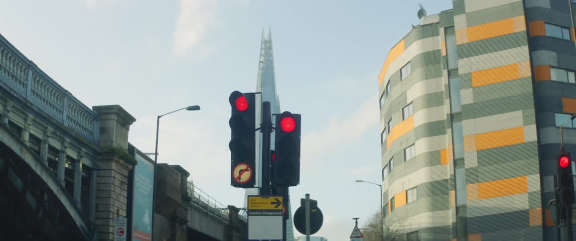 The traffic lights are red in front of the building