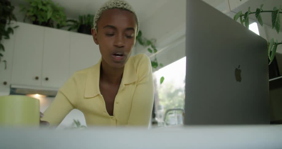 A woman is having a video conversation with someone on a laptop computer