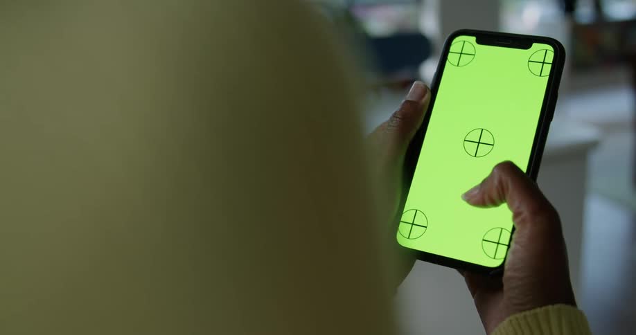 Person wearing long sleeves scrolls smartphone screen