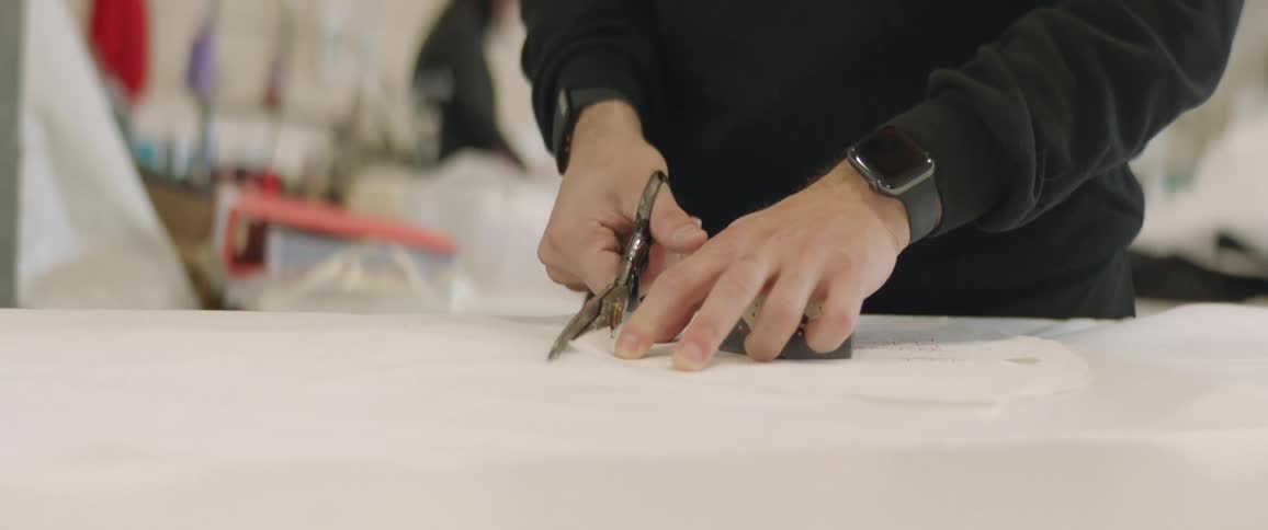 People are working cutting fabric