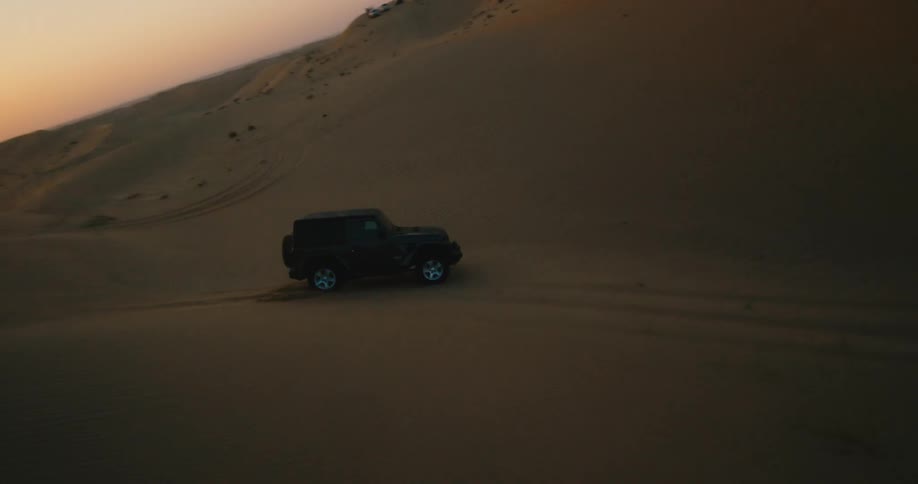 A vehicle is riding through the desert hills