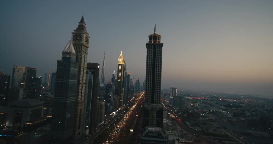 Dubai with lights on and tall buildings high in the sky