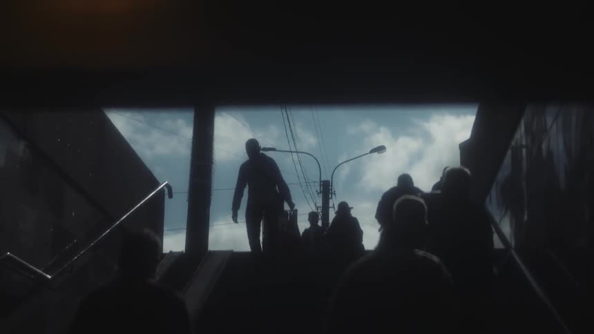 People walk up and down a staircase that leads to and from underground