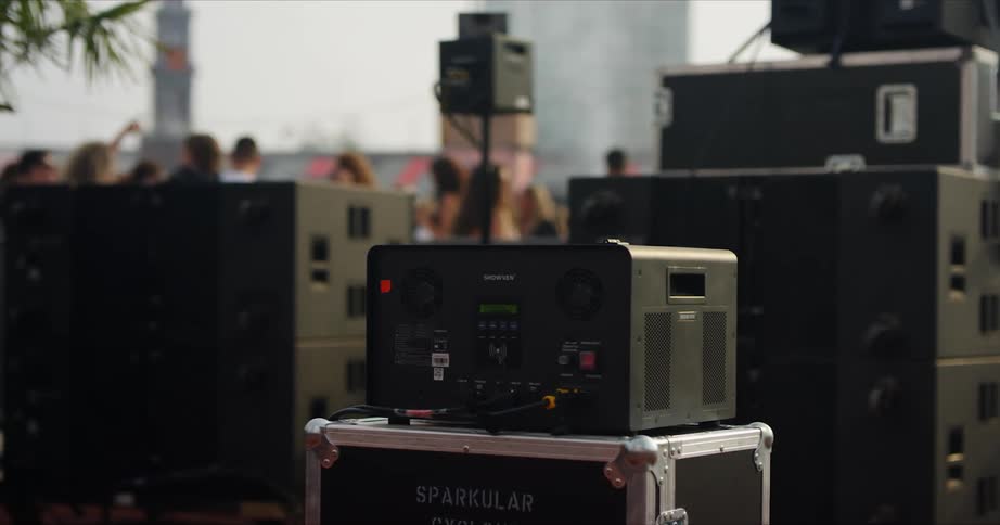 A crowd stands before the empty stage