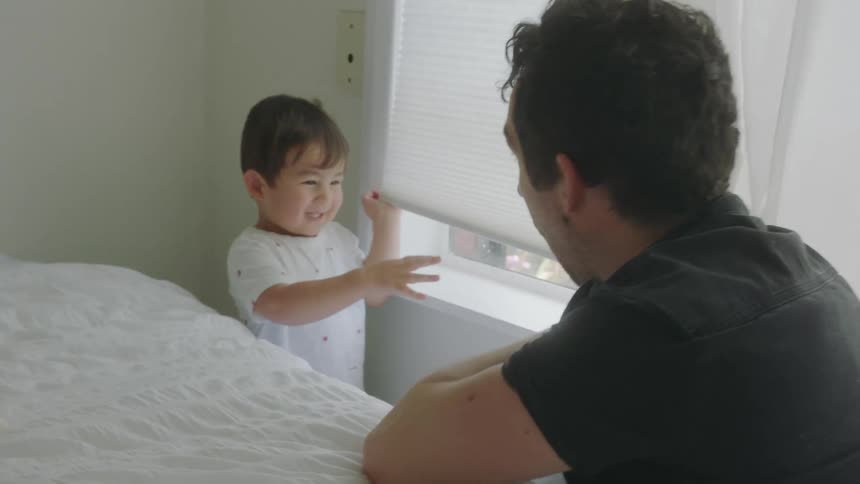 A father and son playing in a house