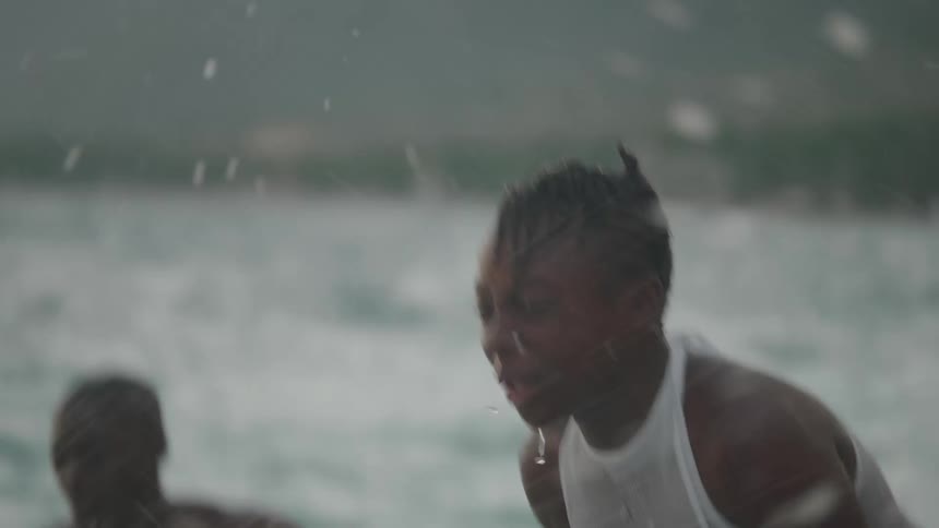 A group of kids are playing and splashing water at each other in the ocean