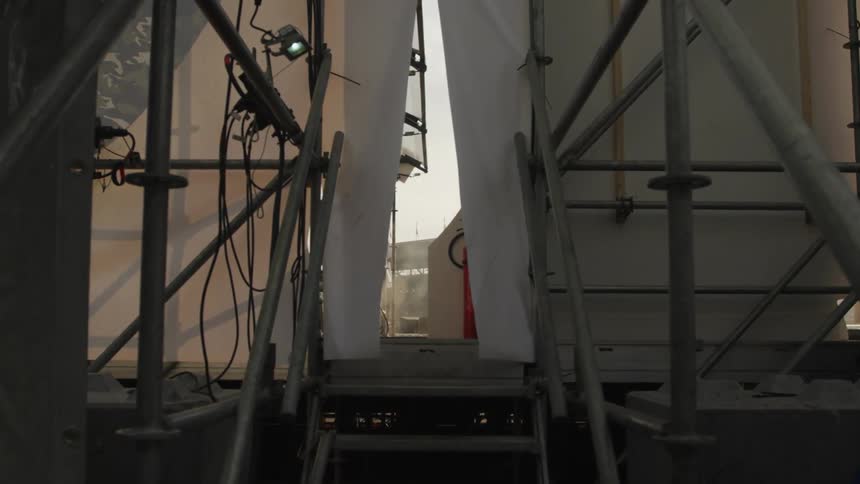 View from onboard a traveling ship while approaching a staircase to go out onto the deck area during the daytime
