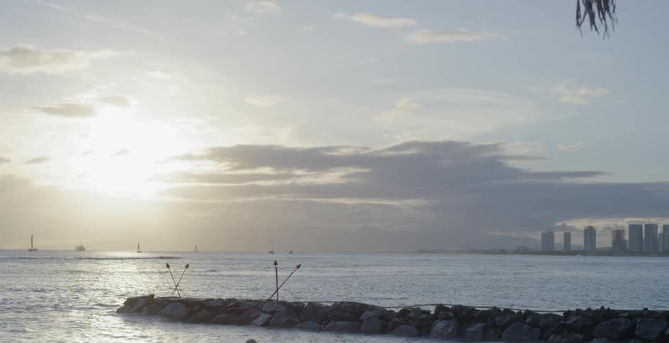 The sun rises over a body of water