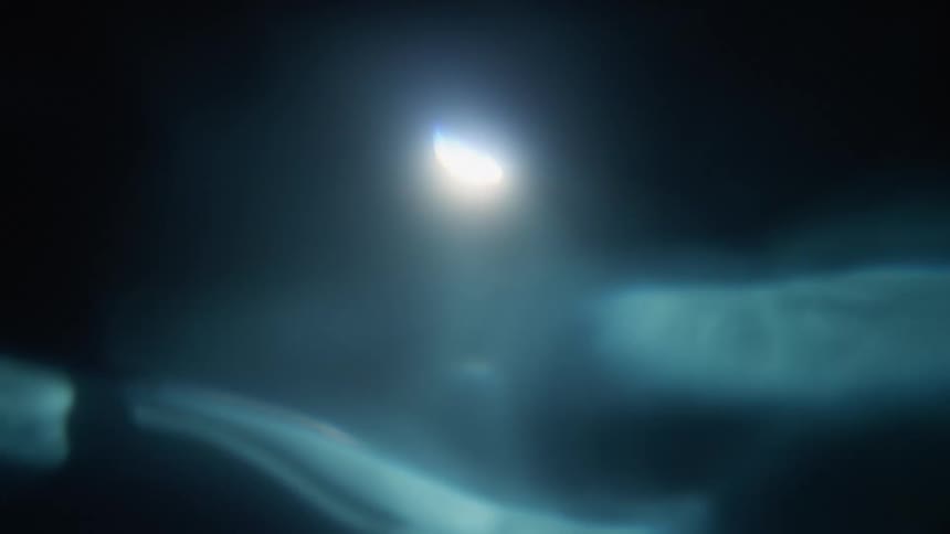 Underwater with ripples and a spotlight above