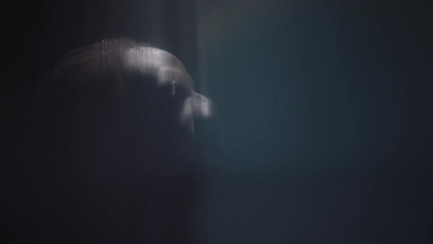 A man is standing in a smoky room