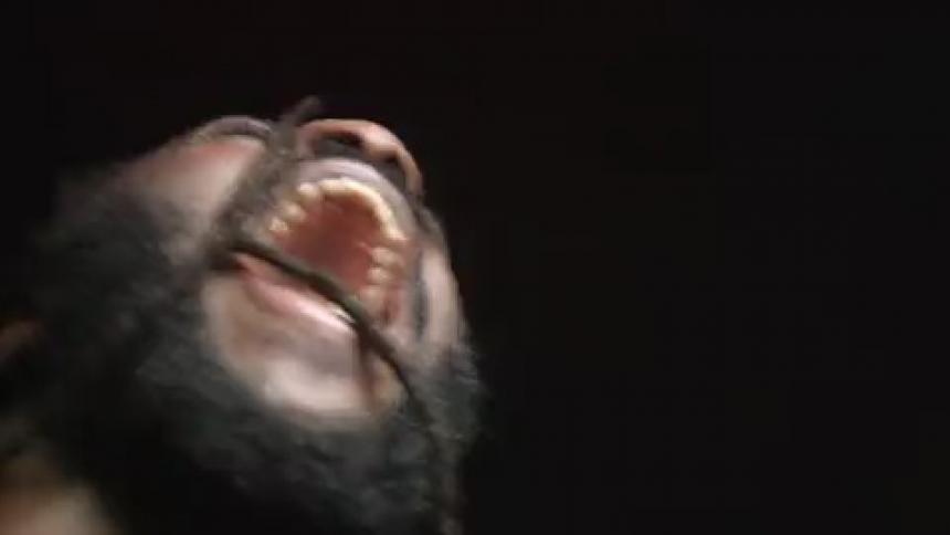 A man that is screaming with a strobe light on